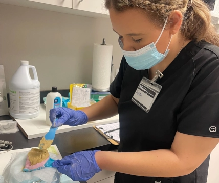 dental assistant student creating a dental impression